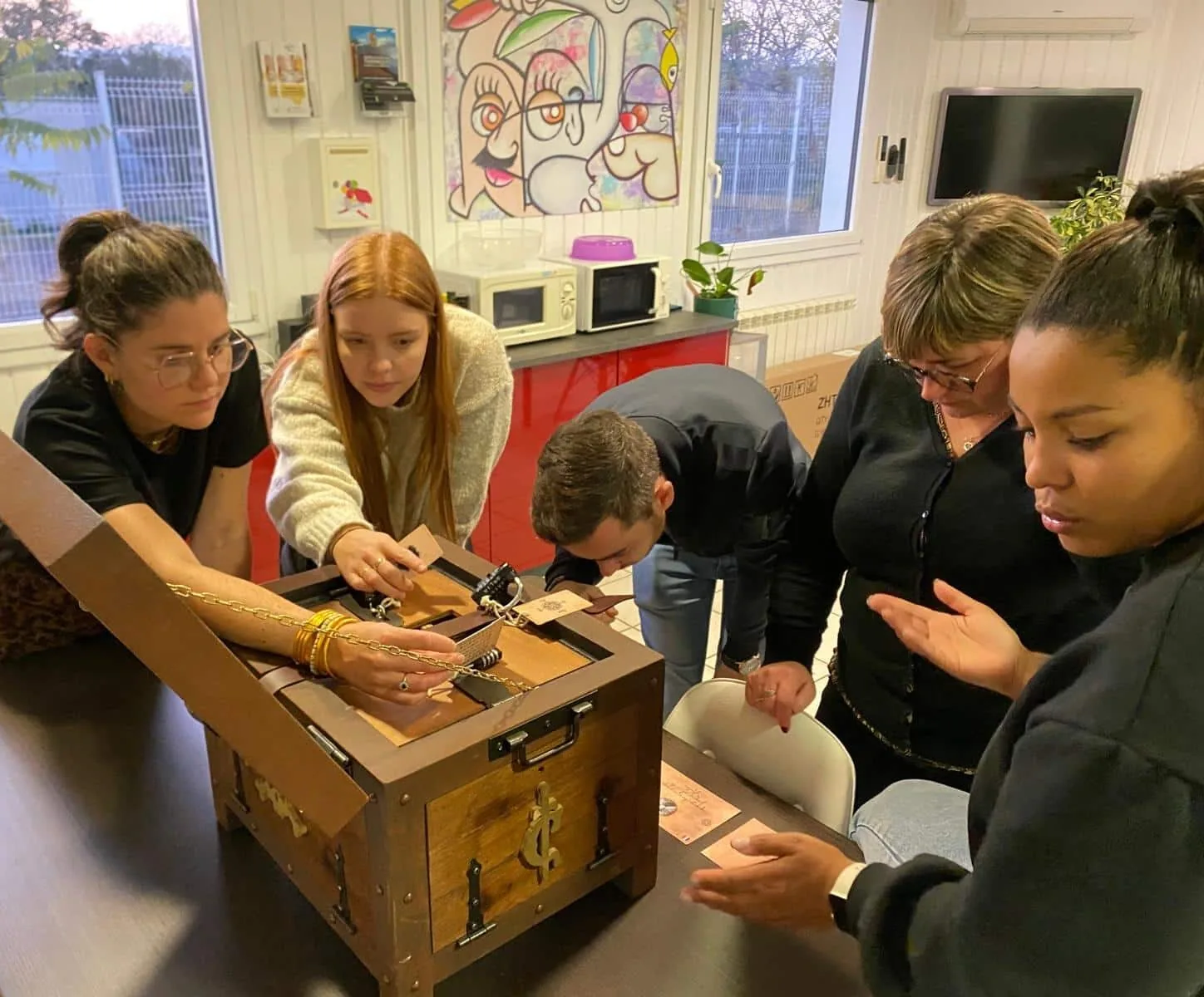Une équipe de coworkers résolvant une escape box en entreprise. Location d'escape box à domicile